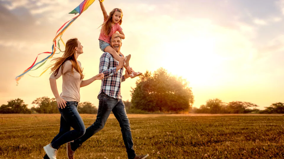 Family,Running,Through,Field,Letting,Kite,Fly